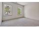 Bedroom with neutral carpet, two windows with nature views, and neutral paint at 82 Bridgeview Rd., Georgetown, SC 29440