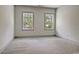 Bedroom with neutral carpet, two windows with nature views, and neutral paint at 82 Bridgeview Rd., Georgetown, SC 29440