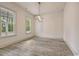 Spacious living room with light gray floors, neutral walls, and modern light fixture at 82 Bridgeview Rd., Georgetown, SC 29440