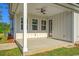 Covered patio with a ceiling fan, a concrete floor, and white posts with siding at 82 Bridgeview Rd., Georgetown, SC 29440