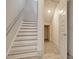 Staircase with wood flooring and white risers, leading to a carpeted upstairs and an open door at 82 Bridgeview Rd., Georgetown, SC 29440