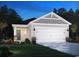 Charming single-story home with stone accents, a two-car garage, and well-maintained landscaping at 822 Cypress Preserve Circle, Longs, SC 29568