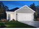 Charming single-Gathering home featuring a two-car garage and inviting front yard with lush landscaping at 826 Cypress Preserve Circle, Longs, SC 29568