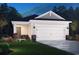 Charming single Gathering home showcasing a two-car garage and well-maintained landscaping at 854 Cypress Preserve Circle, Longs, SC 29568
