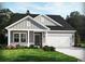 Charming single-Gathering home boasting stone accents, lush landscaping, and a two-car garage at 929 Maya Layne Dr., Little River, SC 29566