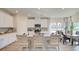 Modern kitchen featuring white cabinets, stainless steel appliances, breakfast bar, and adjacent dining area at 929 Maya Layne Dr., Little River, SC 29566