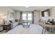 Cozy living room featuring a gray sectional sofa, modern coffee table, and stylish decor at 929 Maya Layne Dr., Little River, SC 29566