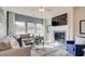 Cozy living room with fireplace, large windows, and comfortable seating area at 929 Maya Layne Dr., Little River, SC 29566
