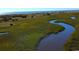 Beautiful aerial shot of a winding river flowing through a green marsh landscape at 929 Maya Layne Dr., Little River, SC 29566