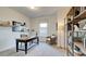 Comfortable office space featuring a large black desk, open shelving, and natural light at 929 Maya Layne Dr., Little River, SC 29566
