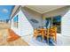Charming outdoor patio with a wooden dining set and a decorative metal wall hanging at 929 Maya Layne Dr., Little River, SC 29566