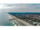 Panoramic aerial view showcasing coastline, pier, residential area and lush greenery, ideal for coastal living at 999 Algonquin Dr. # E, Pawleys Island, SC 29585