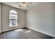 A bedroom with hardwood floors, white walls, and a large window at 999 Algonquin Dr. # E, Pawleys Island, SC 29585