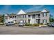 Multi-story condo featuring gray siding, black shutters, and access stairs at 999 Algonquin Dr. # E, Pawleys Island, SC 29585