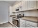 Well-lit kitchen features sleek appliances, granite countertops, and ample cabinet space at 999 Algonquin Dr. # E, Pawleys Island, SC 29585