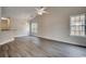 Bright living room with hardwood floors, fan and large windows at 999 Algonquin Dr. # E, Pawleys Island, SC 29585