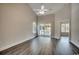Spacious living room with balcony, hardwood floors, and bright windows at 999 Algonquin Dr. # E, Pawleys Island, SC 29585