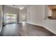 Spacious living room with vaulted ceilings and sliding door, featuring modern flooring and open floor plan at 999 Algonquin Dr. # E, Pawleys Island, SC 29585