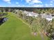 Aerial view of a beautiful condo community next to a lush golf course and a tranquil pond at 1009 World Tour Blvd. # 103, Myrtle Beach, SC 29579
