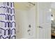 The bathroom features a shower-tub combo with white tile, and shower curtain at 1009 World Tour Blvd. # 103, Myrtle Beach, SC 29579