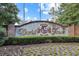 Elegant entrance to World Tour Golf Links featuring a decorative brick sign amidst colorful flowers at 1009 World Tour Blvd. # 103, Myrtle Beach, SC 29579