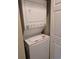 Compact laundry closet with a stacked washer and dryer unit at 1009 World Tour Blvd. # 103, Myrtle Beach, SC 29579