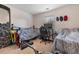 Bedroom with a black metal bed frame, dark gaming chair, and wall decor at 117 Butkus Dr. # 1, Myrtle Beach, SC 29588