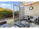 Relaxing screened-in porch featuring wicker seating and an outdoor view at 117 Butkus Dr. # 1, Myrtle Beach, SC 29588