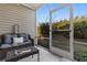 Cozy screened porch with comfortable wicker furniture and view of the backyard at 117 Butkus Dr. # 1, Myrtle Beach, SC 29588