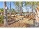 Lush backyard with mature trees and serene lake views, creating a peaceful retreat at 120 Henry Middleton Blvd., Myrtle Beach, SC 29588