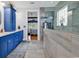 Modern bathroom showcasing blue vanity cabinets and a luxurious glass-enclosed shower at 120 Henry Middleton Blvd., Myrtle Beach, SC 29588