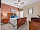 Bedroom with a wooden bed frame, ceiling fan, neutral-toned walls, and a decorative beach-themed art piece at 120 Henry Middleton Blvd., Myrtle Beach, SC 29588