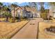 Beautiful home with a stone facade, well-manicured lawn, and a long driveway with a custom design at 120 Henry Middleton Blvd., Myrtle Beach, SC 29588
