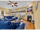 Cozy living room with a fireplace, comfortable seating, hardwood floors, and large windows at 120 Henry Middleton Blvd., Myrtle Beach, SC 29588