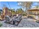 Relaxing outdoor patio with a stone fireplace, comfortable seating, and a built-in grilling area overlooking the lake at 120 Henry Middleton Blvd., Myrtle Beach, SC 29588