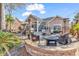 Expansive outdoor patio with a built-in grill, fire pit, and comfortable seating, perfect for outdoor entertaining at 120 Henry Middleton Blvd., Myrtle Beach, SC 29588