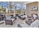 Inviting sunroom with wicker furniture and large windows overlooking a tranquil lake at 120 Henry Middleton Blvd., Myrtle Beach, SC 29588
