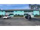 Two-story building has a colorful facade, staircase access, and ample parking at 1200 5Th Ave. N # 1407, Surfside Beach, SC 29575