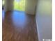 Living room with bright window and gleaming laminated wood floors at 1200 5Th Ave. N # 1407, Surfside Beach, SC 29575