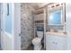 Colorful half-bathroom with charming wallpaper and a white wicker shelf at 1210 N Waccamaw Dr. # 212, Garden City Beach, SC 29576