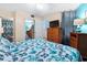 Relaxing bedroom area with wicker furniture and a flatscreen television at 1210 N Waccamaw Dr. # 212, Garden City Beach, SC 29576