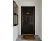 Condo entrance with a dark-colored door, unit number, and 'Welcome' mat at 1210 N Waccamaw Dr. # 212, Garden City Beach, SC 29576