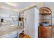 Cozy kitchen area with blue cabinets, white appliances, and a charming breakfast nook with wicker furniture at 1210 N Waccamaw Dr. # 212, Garden City Beach, SC 29576