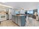 Open-concept kitchen featuring blue cabinets and granite countertops, seamlessly flowing into the living area with ocean views at 1210 N Waccamaw Dr. # 212, Garden City Beach, SC 29576