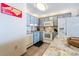 Bright kitchen featuring blue cabinets, white appliances, and granite countertops, perfect for cooking and entertaining guests at 1210 N Waccamaw Dr. # 212, Garden City Beach, SC 29576