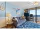 Cozy living room with ocean views and a comfortable couch accented with pillows and a decorative seaside theme at 1210 N Waccamaw Dr. # 212, Garden City Beach, SC 29576