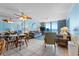 Comfortable living room with coastal decor, featuring plush seating and sliding glass doors leading to a balcony with ocean views at 1210 N Waccamaw Dr. # 212, Garden City Beach, SC 29576