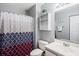 Functional bathroom with a vanity sink, matching mirror, and colorful shower curtain at 1220 River Oak Dr. # 22C, Myrtle Beach, SC 29579