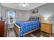 Bright bedroom featuring a bed with plaid patterned bedding, side table, and gray walls at 1220 River Oak Dr. # 22C, Myrtle Beach, SC 29579