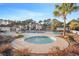 Relaxing hot tub surrounded by lush greenery near the main pool and seating area at 1220 River Oak Dr. # 22C, Myrtle Beach, SC 29579